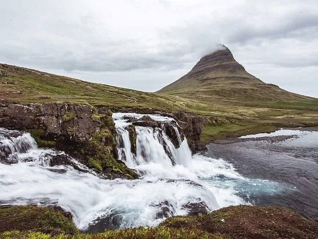 Kirkjufell mountain and waterfall in Iceland on a cloudy day